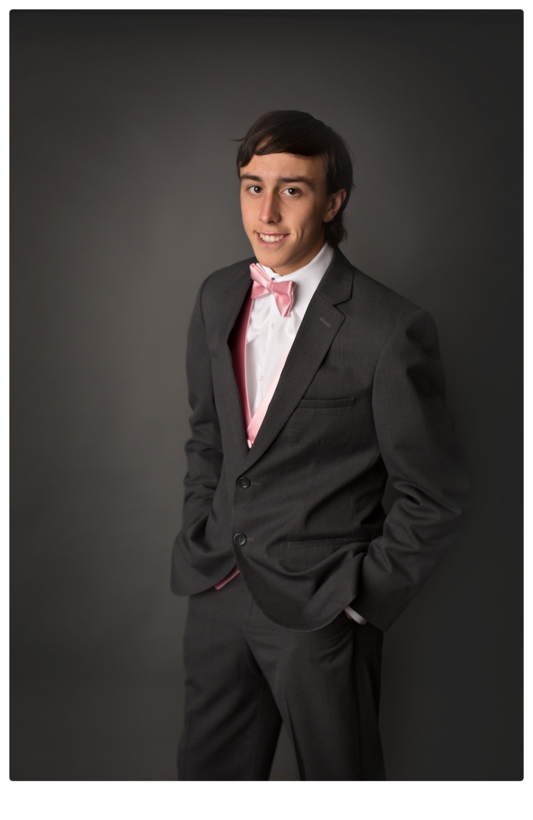 Sonora senior portrait photographer Christine Dibble Photography takes portraits of couples before the Summerville High School prom in a field wet from rain with a blue velvet chair.