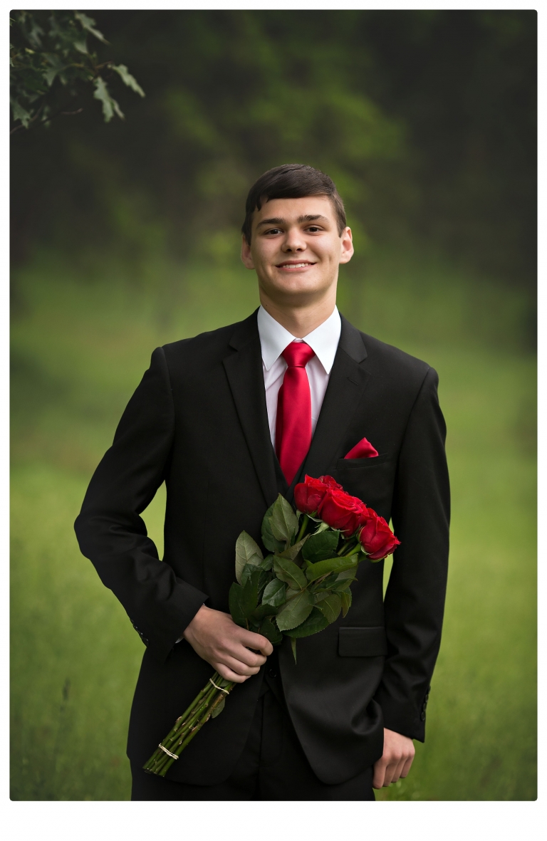 Sonora senior portrait photographer Christine Dibble Photography takes portraits of couples before the Summerville High School prom in a field wet from rain with a blue velvet chair.