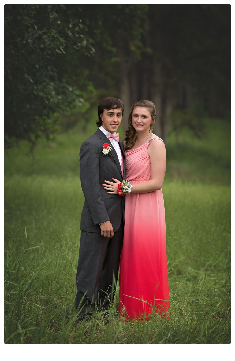 Sonora senior portrait photographer Christine Dibble Photography takes portraits of couples before the Summerville High School prom in a field wet from rain with a blue velvet chair.