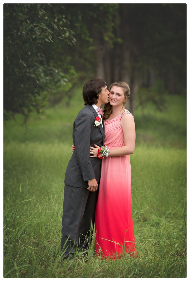 Sonora senior portrait photographer Christine Dibble Photography takes portraits of couples before the Summerville High School prom in a field wet from rain with a blue velvet chair.