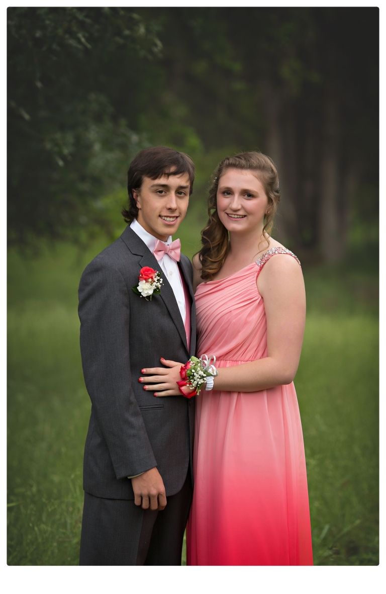 Sonora senior portrait photographer Christine Dibble Photography takes portraits of couples before the Summerville High School prom in a field wet from rain with a blue velvet chair.