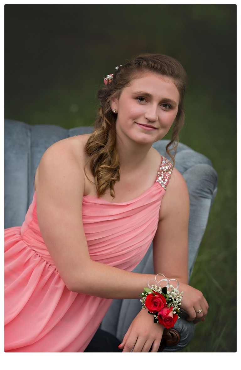 Sonora senior portrait photographer Christine Dibble Photography takes portraits of couples before the Summerville High School prom in a field wet from rain with a blue velvet chair.