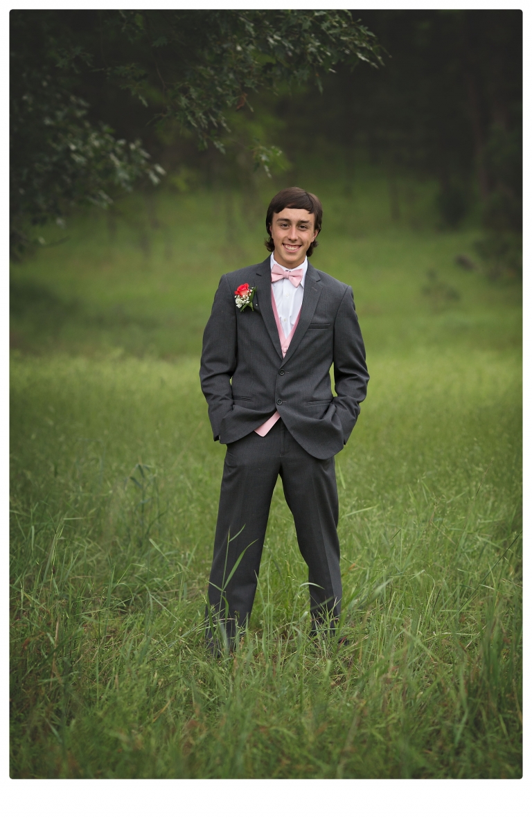 Sonora senior portrait photographer Christine Dibble Photography takes portraits of couples before the Summerville High School prom in a field wet from rain with a blue velvet chair.