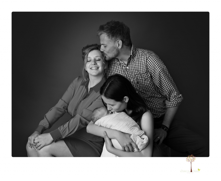Best Sonora Newborn Photographer Christine Dibble Photography takes studio portraits of a baby sister with her parents and older sister and then posed newborn photos of baby alone.