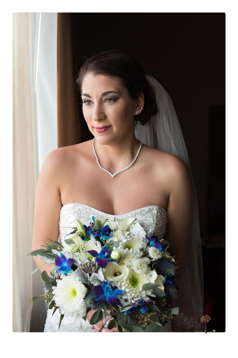 Sonora Wedding Photographer Christine Dibble Photography takes wedding photos at a Black Oak Casino Resort wedding including the bride in the window.