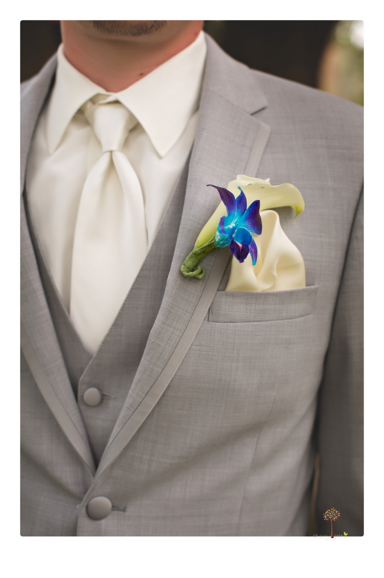 Sonora Wedding Photographer Christine Dibble Photography takes wedding photos at a Black Oak Casino Resort wedding including the groom's blue orchid boutonniere.