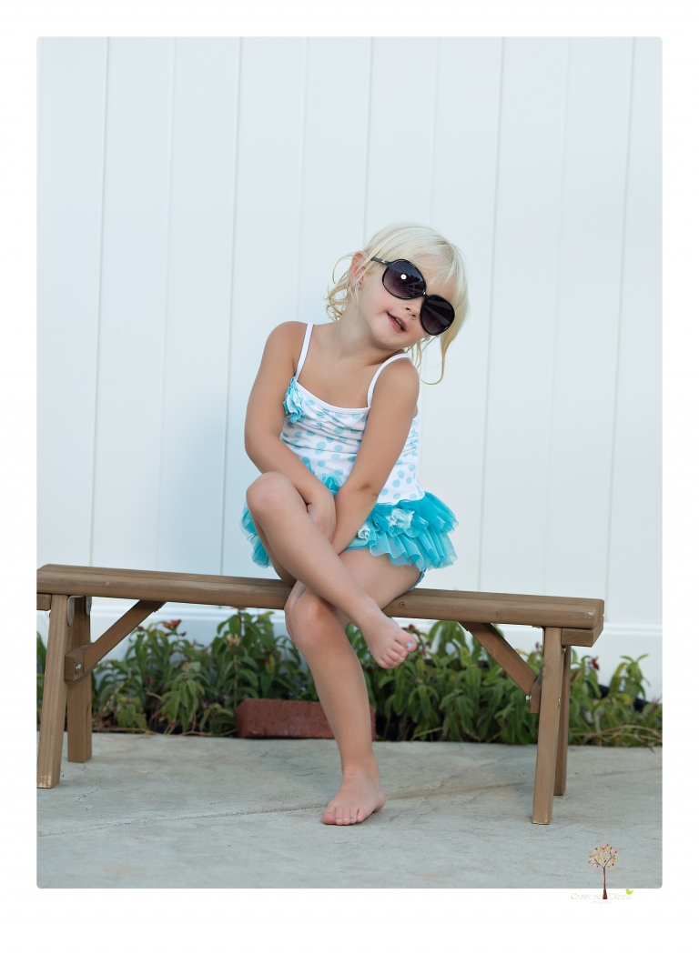 Sonora Child Photographer Christine Dibble Photography takes mermaid birthday photos of a five year old girl in her finfun mermaid tail and a ruffled swimsuit and retro shades.