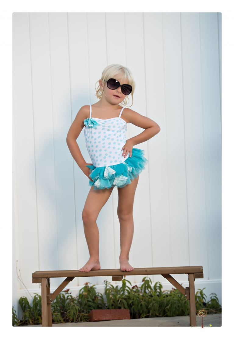 Sonora Child Photographer Christine Dibble Photography takes mermaid birthday photos of a five year old girl in her finfun mermaid tail and a ruffled swimsuit and retro shades.