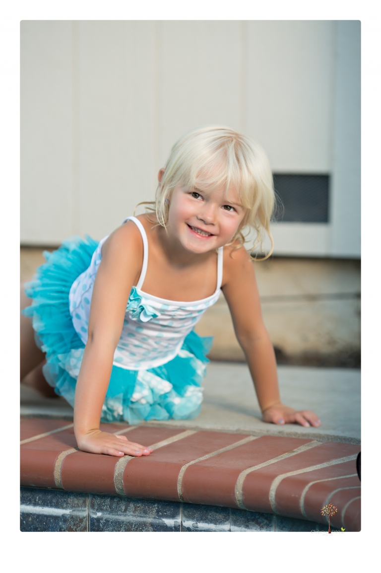 Sonora Child Photographer Christine Dibble Photography takes mermaid birthday photos of a five year old girl in her finfun mermaid tail and a ruffled swimsuit and retro shades.