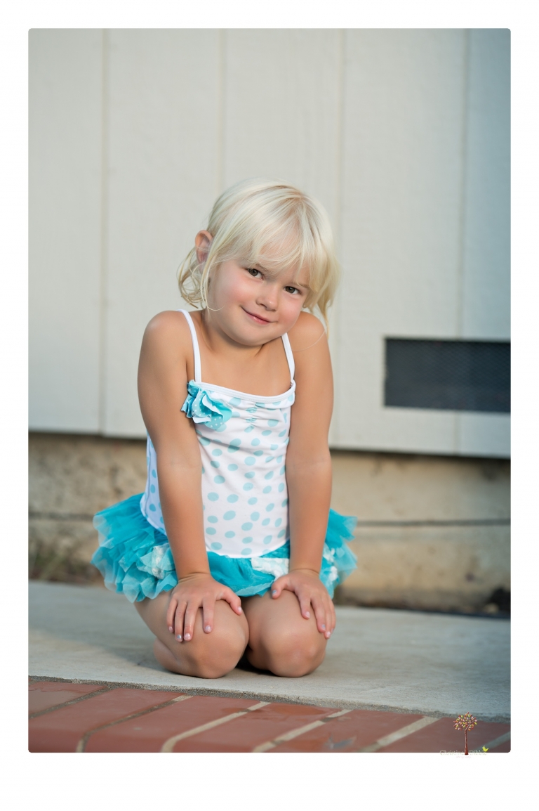 Sonora Child Photographer Christine Dibble Photography takes mermaid birthday photos of a five year old girl in her finfun mermaid tail and a ruffled swimsuit and retro shades.