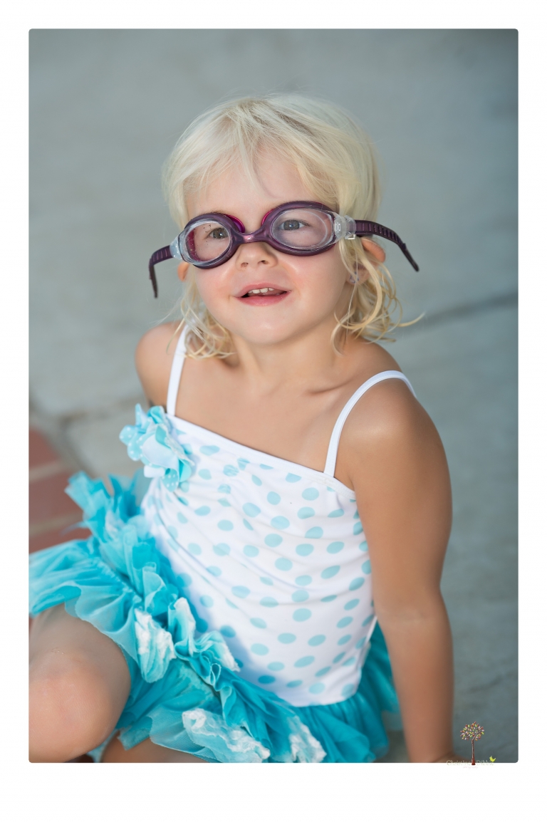 Sonora Child Photographer Christine Dibble Photography takes mermaid birthday photos of a five year old girl in her finfun mermaid tail and a ruffled swimsuit and retro shades.