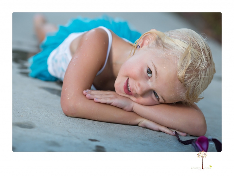 Sonora Child Photographer Christine Dibble Photography takes mermaid birthday photos of a five year old girl in her finfun mermaid tail and a ruffled swimsuit and retro shades.