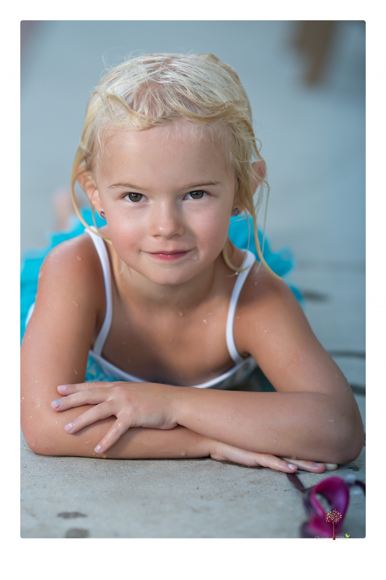 Sonora Child Photographer Christine Dibble Photography takes mermaid birthday photos of a five year old girl in her finfun mermaid tail and a ruffled swimsuit and retro shades.