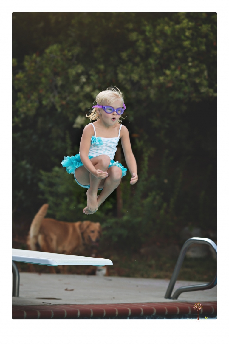 Sonora Child Photographer Christine Dibble Photography takes mermaid birthday photos of a five year old girl in her finfun mermaid tail and a ruffled swimsuit and retro shades.