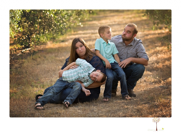 Sonora family photographer Christine Dibble Photography photographs a pregnancy announcement at Hurst Ranch as a wife tells her husband she is pregnant with baby number three during a family portrait session.
