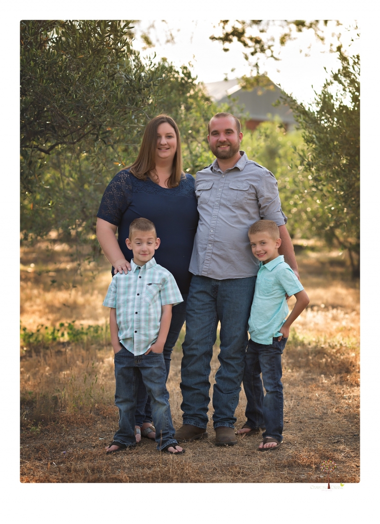 Sonora family photographer Christine Dibble Photography photographs a pregnancy announcement at Hurst Ranch as a wife tells her husband she is pregnant with baby number three during a family portrait session.
