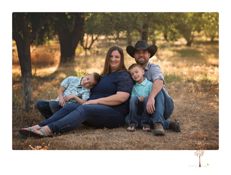Sonora family photographer Christine Dibble Photography photographs a pregnancy announcement at Hurst Ranch as a wife tells her husband she is pregnant with baby number three during a family portrait session.