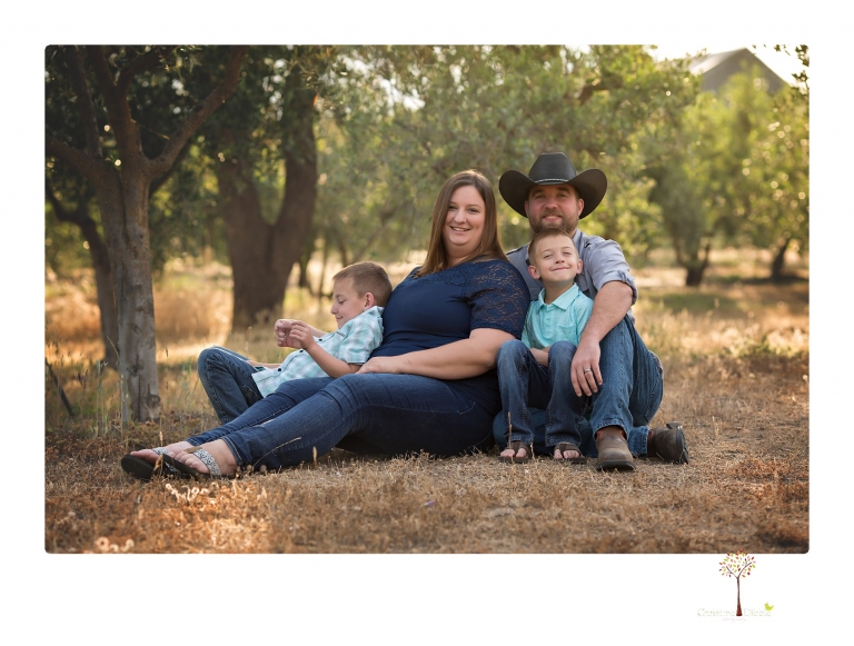 Sonora family photographer Christine Dibble Photography photographs a pregnancy announcement at Hurst Ranch as a wife tells her husband she is pregnant with baby number three during a family portrait session.
