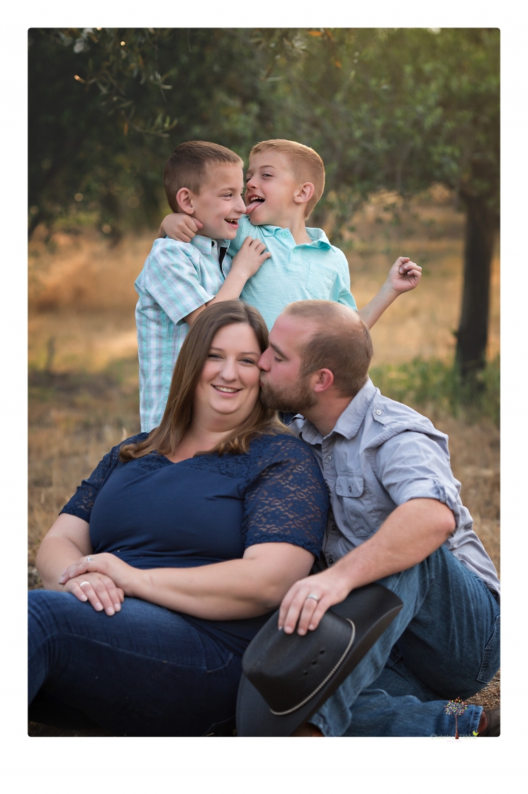 Sonora family photographer Christine Dibble Photography photographs a pregnancy announcement at Hurst Ranch as a wife tells her husband she is pregnant with baby number three during a family portrait session.