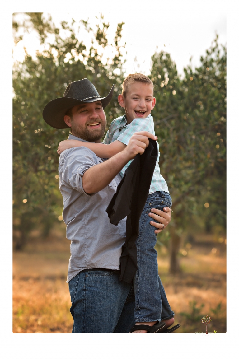Sonora family photographer Christine Dibble Photography photographs a pregnancy announcement at Hurst Ranch as a wife tells her husband she is pregnant with baby number three during a family portrait session.