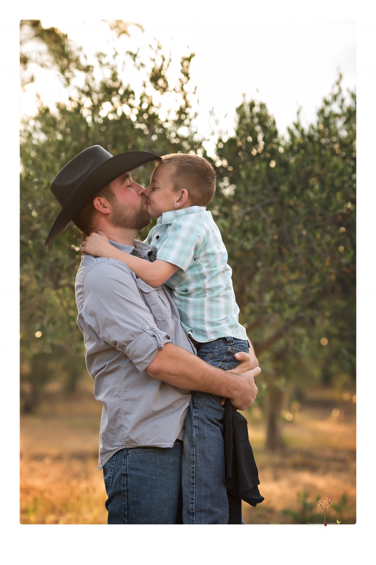 Sonora family photographer Christine Dibble Photography photographs a pregnancy announcement at Hurst Ranch as a wife tells her husband she is pregnant with baby number three during a family portrait session.