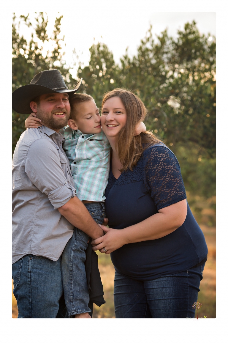 Sonora family photographer Christine Dibble Photography photographs a pregnancy announcement at Hurst Ranch as a wife tells her husband she is pregnant with baby number three during a family portrait session.