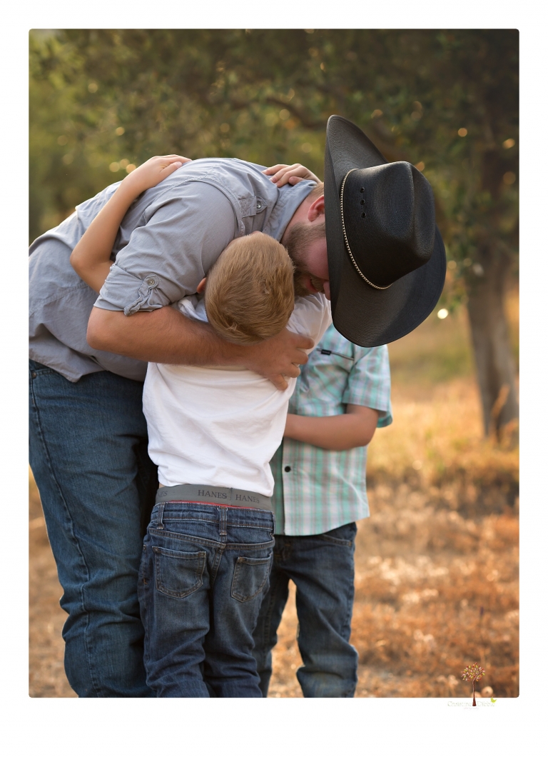 Sonora family photographer Christine Dibble Photography photographs a pregnancy announcement at Hurst Ranch as a wife tells her husband she is pregnant with baby number three during a family portrait session.