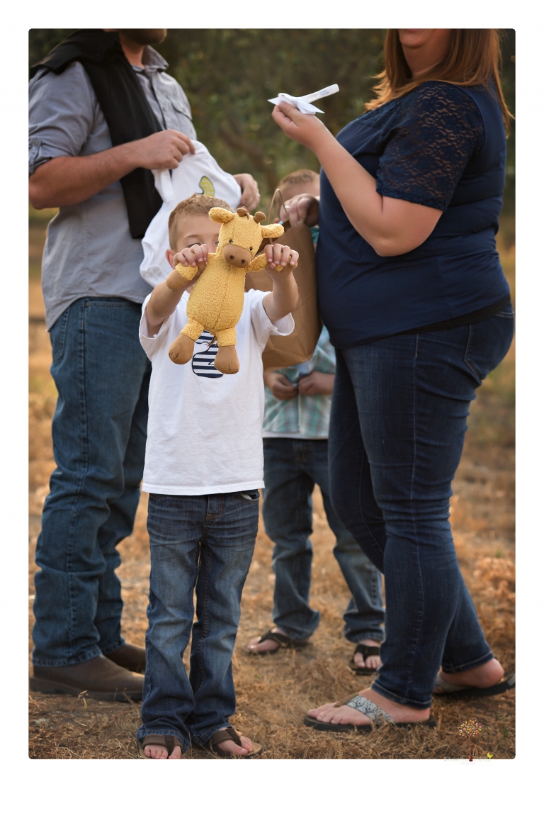 Sonora family photographer Christine Dibble Photography photographs a pregnancy announcement at Hurst Ranch as a wife tells her husband she is pregnant with baby number three during a family portrait session.
