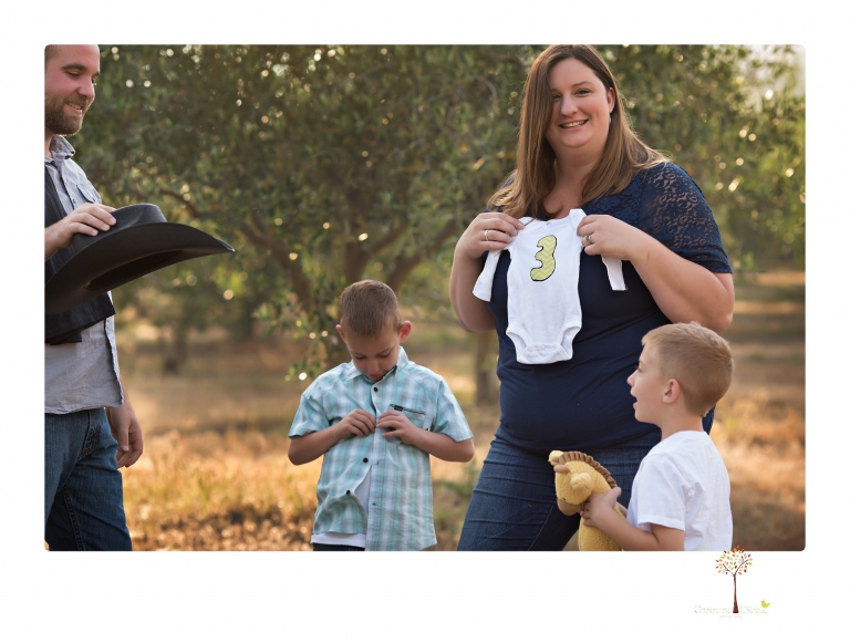 Sonora family photographer Christine Dibble Photography photographs a pregnancy announcement at Hurst Ranch as a wife tells her husband she is pregnant with baby number three during a family portrait session.