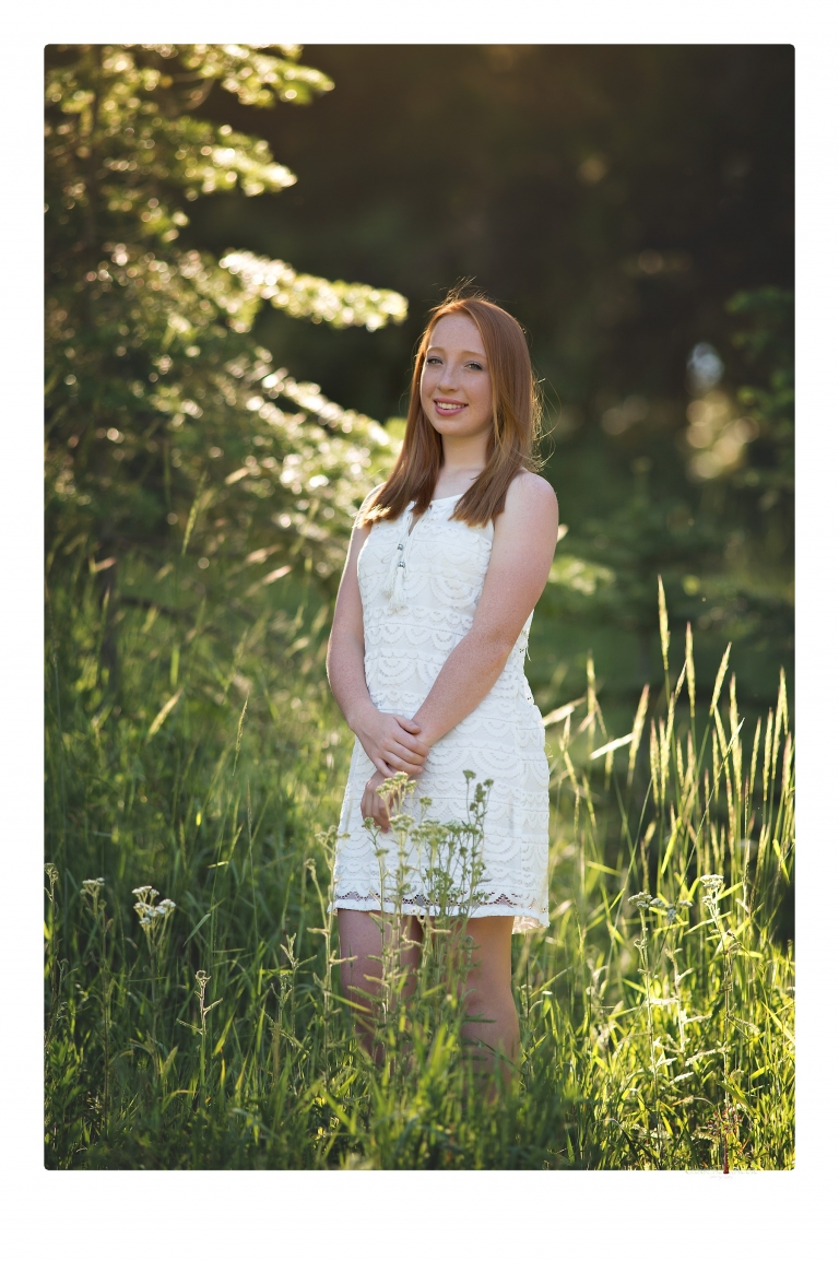 Sonora Graduation Photographer Christine Dibble Photography takes portraits of a red headed eighth grade graduate at her eighth grade graduation portrait session outside of Long Barn in fields of flowers.