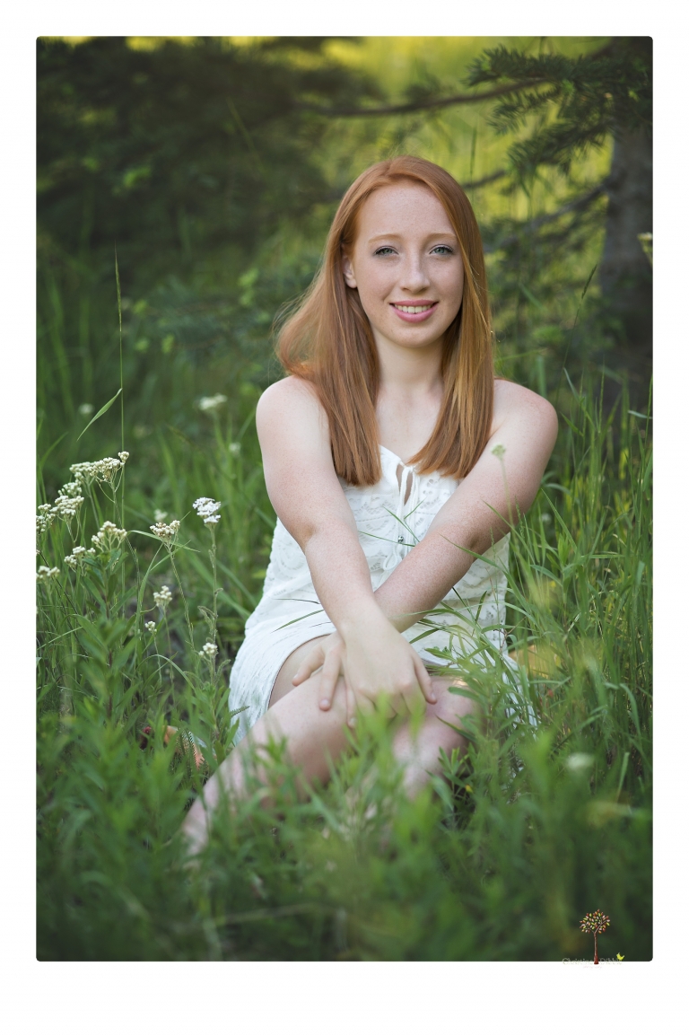 Sonora Graduation Photographer Christine Dibble Photography takes portraits of a red headed eighth grade graduate at her eighth grade graduation portrait session outside of Long Barn in fields of flowers.
