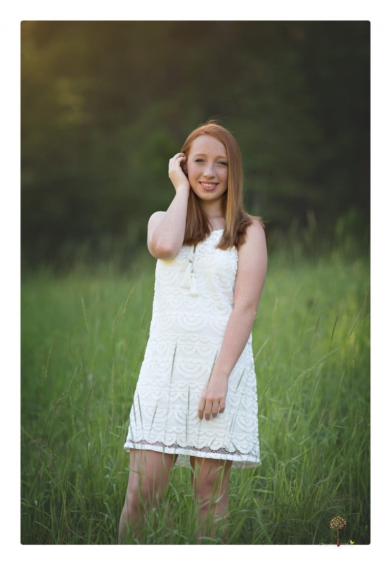 Sonora Graduation Photographer Christine Dibble Photography takes portraits of a red headed eighth grade graduate at her eighth grade graduation portrait session outside of Long Barn in fields of flowers.