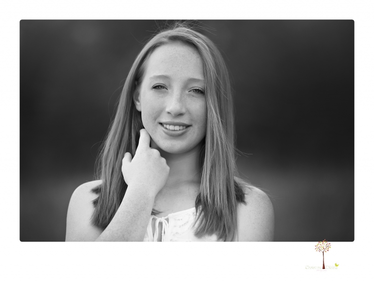 Sonora Graduation Photographer Christine Dibble Photography takes portraits of a red headed eighth grade graduate at her eighth grade graduation portrait session outside of Long Barn in fields of flowers.