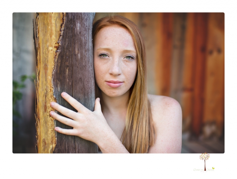 Sonora Graduation Photographer Christine Dibble Photography takes portraits of a red headed eighth grade graduate at her eighth grade graduation portrait session outside of Long Barn in fields of flowers.