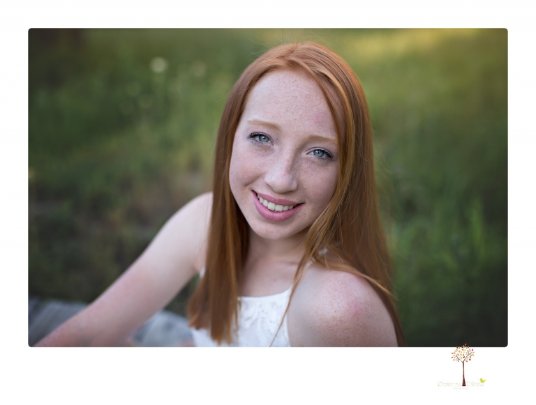Sonora Graduation Photographer Christine Dibble Photography takes portraits of a red headed eighth grade graduate at her eighth grade graduation portrait session outside of Long Barn in fields of flowers.