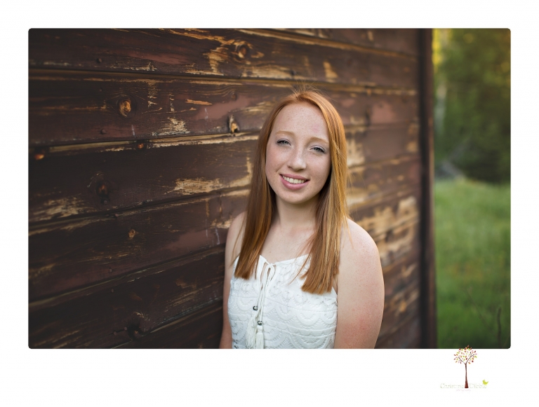 Sonora Graduation Photographer Christine Dibble Photography takes portraits of a red headed eighth grade graduate at her eighth grade graduation portrait session outside of Long Barn in fields of flowers.