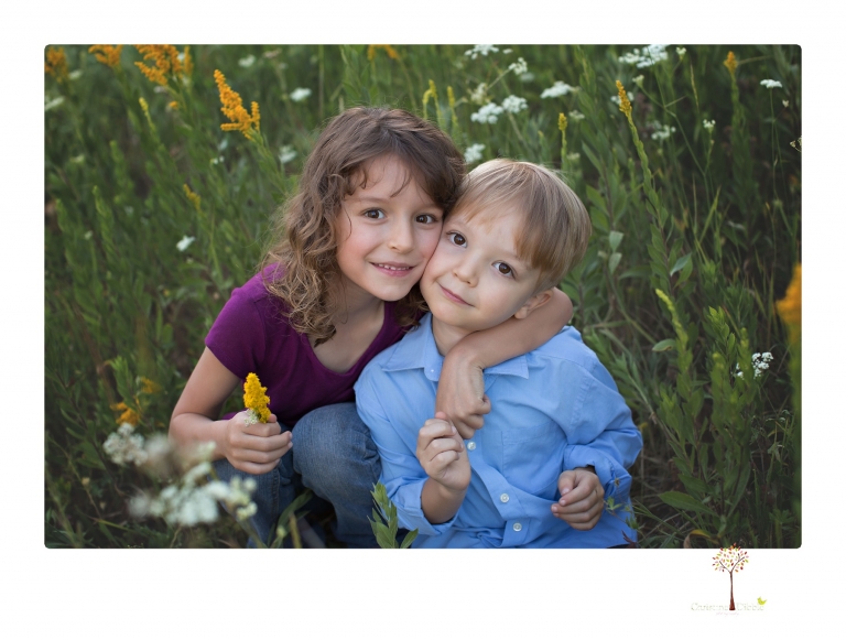 Sonora maternity photographer Christine Dibble Photography takes family maternity portraits of a mom expecting twins  in a wildflower field near Long Barn.