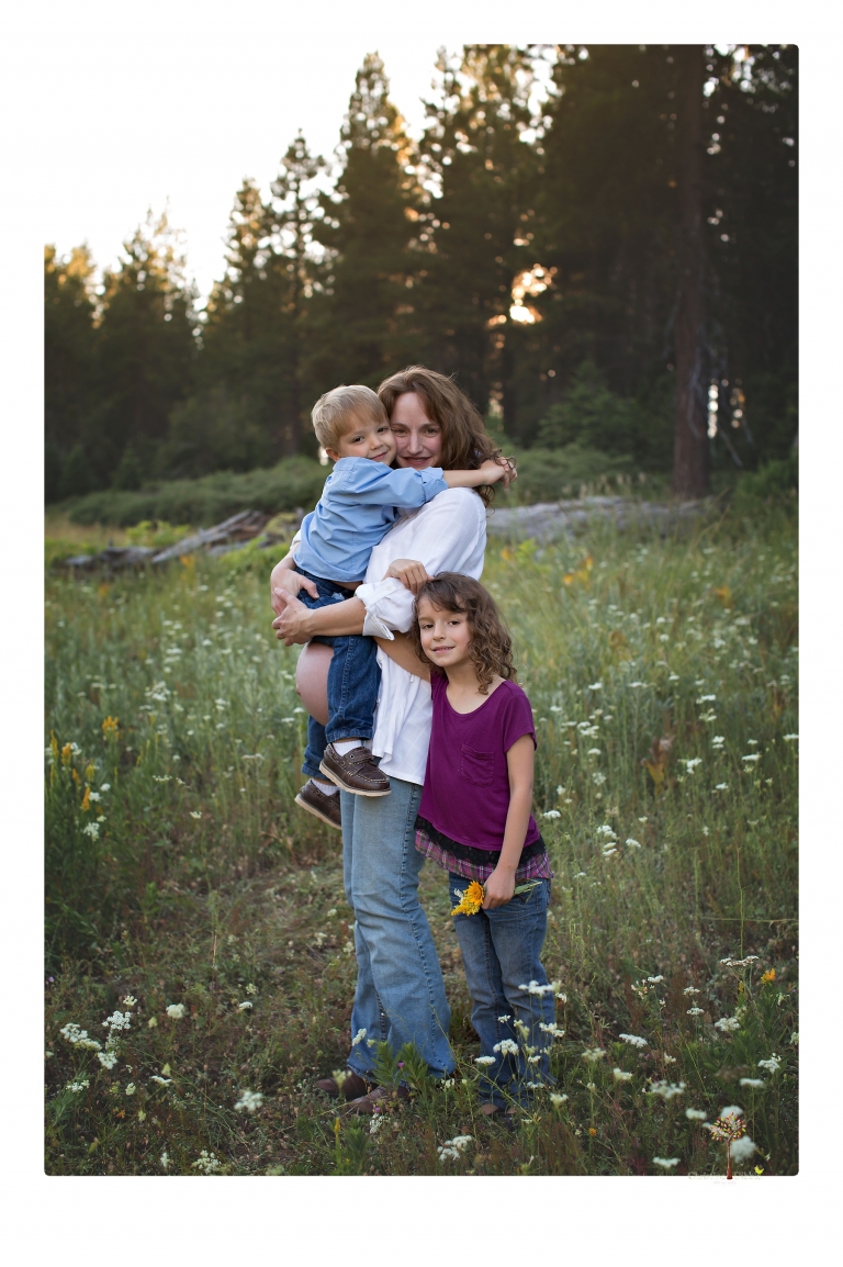 Sonora maternity photographer Christine Dibble Photography takes family maternity portraits of a mom expecting twins  in a wildflower field near Long Barn.