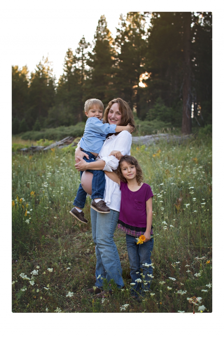 Sonora maternity photographer Christine Dibble Photography takes family maternity portraits of a mom expecting twins  in a wildflower field near Long Barn.