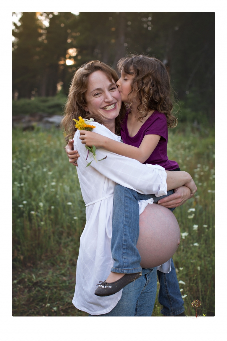 Sonora maternity photographer Christine Dibble Photography takes family maternity portraits of a mom expecting twins  in a wildflower field near Long Barn.