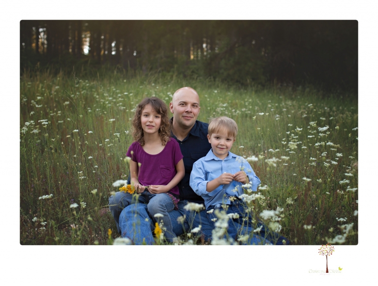 Sonora maternity photographer Christine Dibble Photography takes family maternity portraits of a mom expecting twins  in a wildflower field near Long Barn.