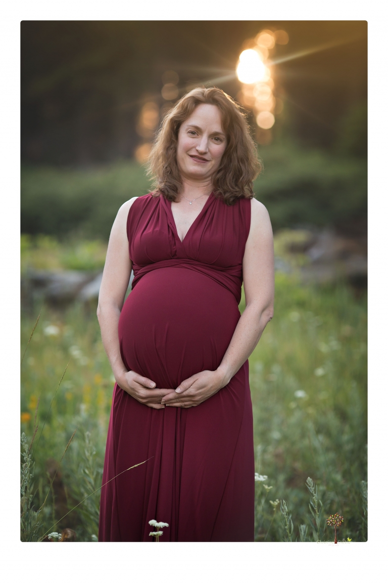 Sonora maternity photographer Christine Dibble Photography takes family maternity portraits of a mom expecting twins  in a wildflower field near Long Barn.