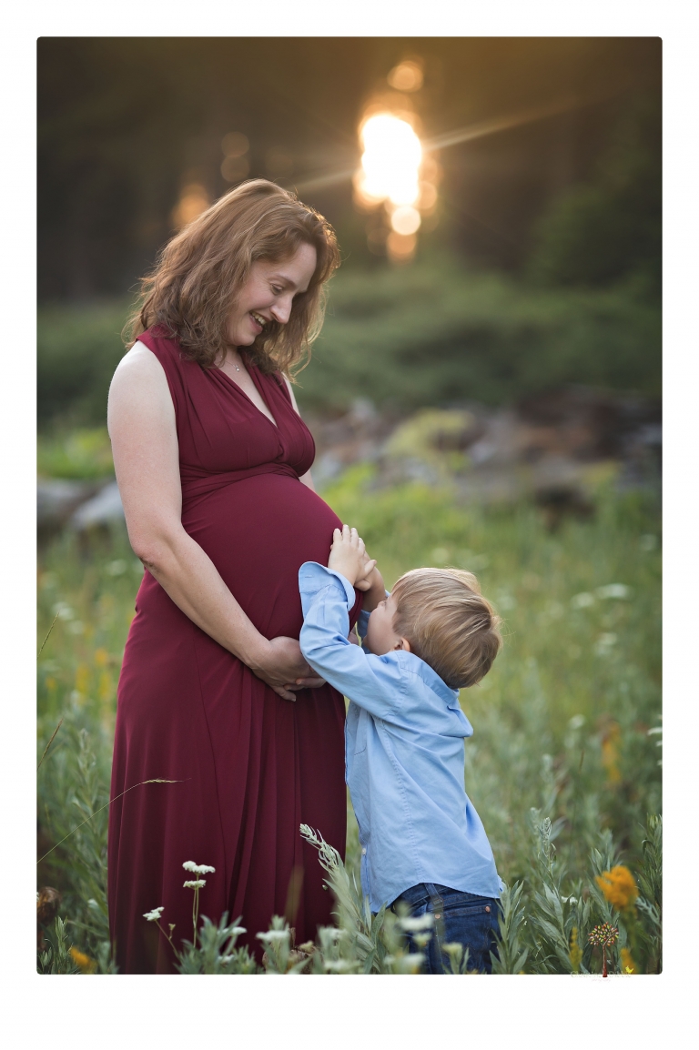 Sonora maternity photographer Christine Dibble Photography takes family maternity portraits of a mom expecting twins  in a wildflower field near Long Barn.