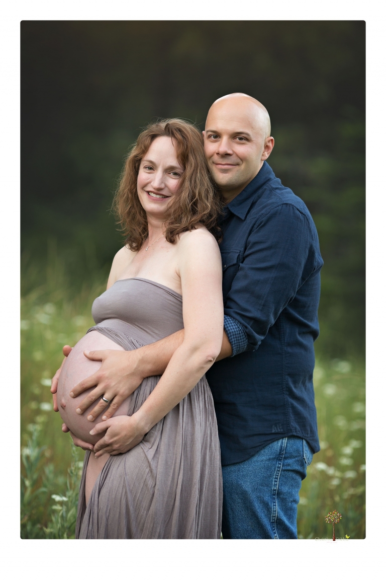 Sonora maternity photographer Christine Dibble Photography takes family maternity portraits of a mom expecting twins  in a wildflower field near Long Barn.