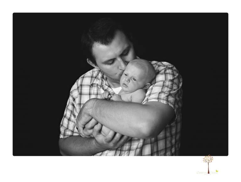 Best Sonora newborn photographer Christine Dibble Photography takes newborn portraits of a baby boy in the studio with his dad's firefighting gear.