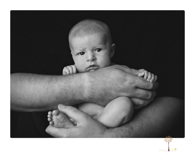 Best Sonora newborn photographer Christine Dibble Photography takes newborn portraits of a baby boy in the studio with his dad's firefighting gear.