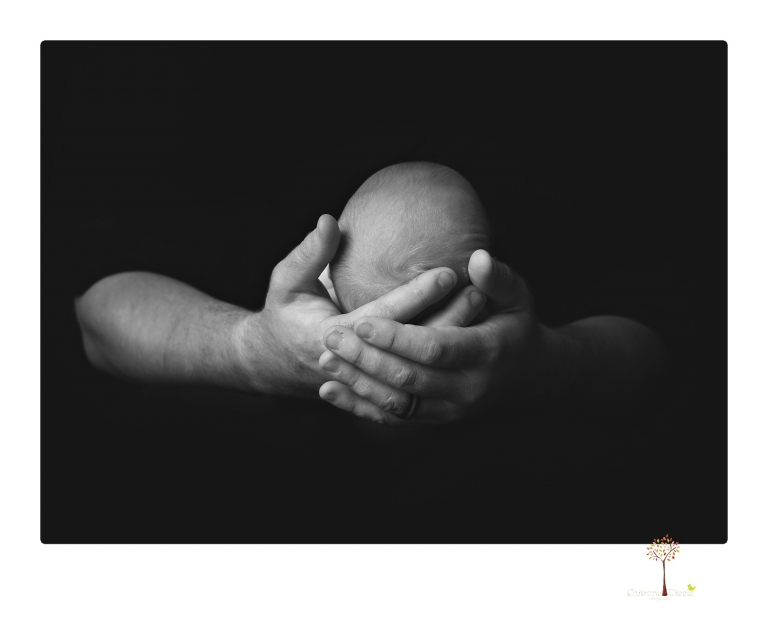 Best Sonora newborn photographer Christine Dibble Photography takes newborn portraits of a baby boy in the studio with his dad's firefighting gear.
