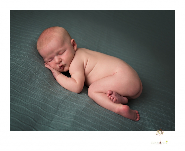 Best Sonora newborn photographer Christine Dibble Photography takes newborn portraits of a baby boy in the studio with his dad's firefighting gear.