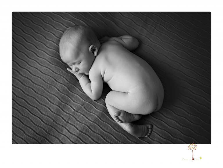 Best Sonora newborn photographer Christine Dibble Photography takes newborn portraits of a baby boy in the studio with his dad's firefighting gear.