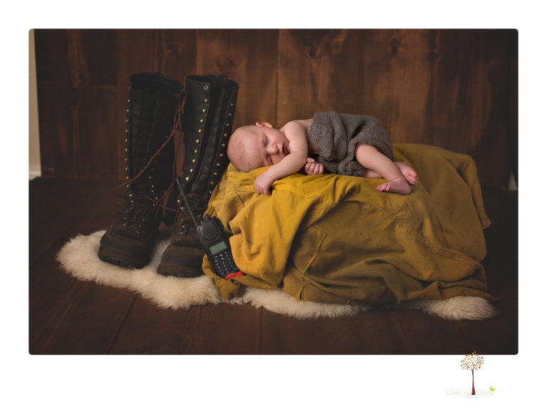 Best Sonora newborn photographer Christine Dibble Photography takes newborn portraits of a baby boy in the studio with his dad's firefighting gear.